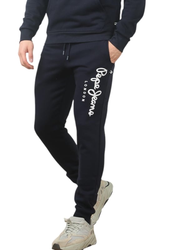 The Pepe Jeans London men's regular fit tracksuit set offers a soft and lightweight hoodie paired with matching joggers. The hoodie features ribbed details on the hood, cuffs, and hem, along with an adjustable hood and a kangaroo pocket for convenience. The joggers come with a waistband drawstring for a secure fit. Both pieces showcase the Pepe Jeans London Big logo on the chest for the hoodie and the left leg for the joggers. A decorative inner neckband with an all-over logo adds a stylish touch. Made from 100% sustainable cotton, the fabric consists of 65% cotton and 35% polyester. The set is a washable machine for easy maintenance.