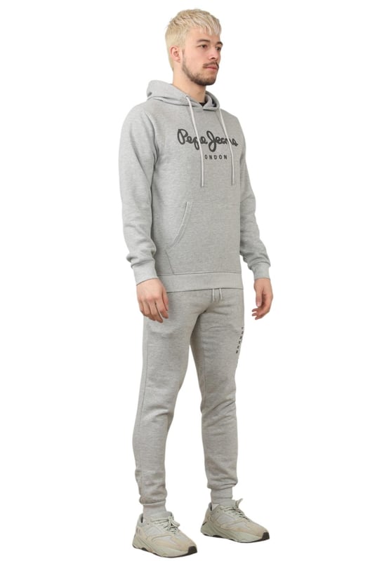 The Pepe Jeans London men's regular fit tracksuit set offers a soft and lightweight hoodie paired with matching joggers. The hoodie features ribbed details on the hood, cuffs, and hem, along with an adjustable hood and a kangaroo pocket for convenience. The joggers come with a waistband drawstring for a secure fit. Both pieces showcase the Pepe Jeans London Big logo on the chest for the hoodie and the left leg for the joggers. A decorative inner neckband with an all-over logo adds a stylish touch. Made from 100% sustainable cotton, the fabric consists of 65% cotton and 35% polyester. The set is a washable machine for easy maintenance.