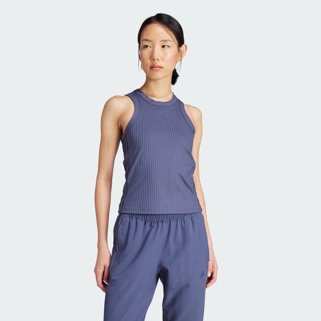 Whether you're crushing cardio, lifting weights or stretching it out, this training tank top moves with you. Stay dry, thanks to adidas AEROREADY. Subtle shine details and tonal 3-Stripes round out the look of this versatile must-have. This product is made with at least 70% recycled materials. By reusing materials that have already been created, adidas help to reduce waste and our reliance on finite resources and reduce the footprint of the products adidas make.  - This model is 178 cm and wears a size 36. Their chest measures 81 cm and the waist 58 cm. - Tight fit - Crewneck - 89% polyester (recycled), 11% elastane - Soft feel - AEROREADY - Moisture-wicking fabric  Shipped by adidas