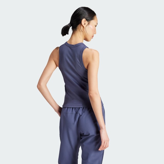 Whether you're crushing cardio, lifting weights or stretching it out, this training tank top moves with you. Stay dry, thanks to adidas AEROREADY. Subtle shine details and tonal 3-Stripes round out the look of this versatile must-have. This product is made with at least 70% recycled materials. By reusing materials that have already been created, adidas help to reduce waste and our reliance on finite resources and reduce the footprint of the products adidas make.  - This model is 178 cm and wears a size 36. Their chest measures 81 cm and the waist 58 cm. - Tight fit - Crewneck - 89% polyester (recycled), 11% elastane - Soft feel - AEROREADY - Moisture-wicking fabric  Shipped by adidas