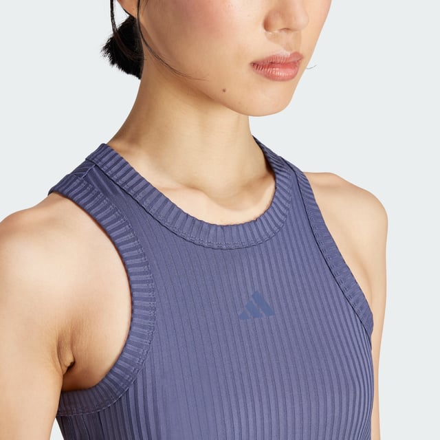 Whether you're crushing cardio, lifting weights or stretching it out, this training tank top moves with you. Stay dry, thanks to adidas AEROREADY. Subtle shine details and tonal 3-Stripes round out the look of this versatile must-have. This product is made with at least 70% recycled materials. By reusing materials that have already been created, adidas help to reduce waste and our reliance on finite resources and reduce the footprint of the products adidas make.  - This model is 178 cm and wears a size 36. Their chest measures 81 cm and the waist 58 cm. - Tight fit - Crewneck - 89% polyester (recycled), 11% elastane - Soft feel - AEROREADY - Moisture-wicking fabric  Shipped by adidas