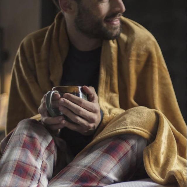It’s what many of you have been waiting for! The phenomenal success of Heat Holders socks has led to several additional products, such as hats and Gloves (and the new Snugover fleece jumper!) and now thermal blankets with all the warmth and comfort known of the Heat Holders technology. Our new Heat Holders Thermal Blanket is made of a luxuriously soft fur-like fleece we call Heatweaver, that has been developed with the main intention of being efficient at retaining heat, which is why it has an official tog rating of 1.7 TOG – it’s measurably warmer to the touch. The Heat Holders Thermal Blanket is a large 180 x 200 cm so it lets you wrap up and unwind on those cosy lounge-around days! It’s incredibly soft and very easy to look after, as it’s fully machine washable. So, with heating costs rising, don’t get cold – get a Heat Holders Thermal Blanket! With many different uses this blanket can fit in any room of the house. It is also a perfect gift for Christmas or any occasion, as it comes packed in a box to make wrapping up easier! A ribbon is also wrapped around the blanket inside the box for those extra presentation points. Available in 16 bright and classic colours, so you can for-sure find one to match your room or pick whatever you fancy!