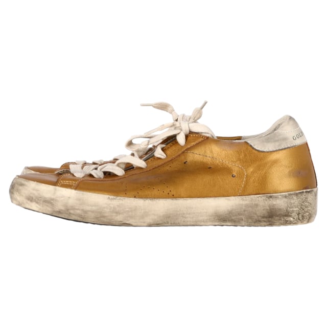 VINTAGE, RRP AS NEW
Add a touch of luxury to your casual wardrobe with the Golden Goose Superstar Perforated Sneakers in gold leather. These sneakers combine effortless street style with high-end craftsmanship, featuring a perforated design that enhances breathability and a sleek metallic gold finish that makes a bold statement. The signature distressed detailing gives them a cool, lived-in look, while the comfortable sole ensures all-day wearability.

Styling Tip: These versatile sneakers pair perfectly with everything from casual jeans and a tee to a chic midi dress for a laid-back yet stylish contrast. For an elevated street style look, pair them with leather leggings or a cropped denim jacket. Whether you're running errands or out for a coffee date, the Golden Goose Superstar sneakers will effortlessly add a touch of glam to any outfit.

 Golden Goose Superstar Perforated Sneakers in Gold Leather

Condition: Excellent
Signs of wear: No visible sign of wear. No Mark at insole.,  Very light mark at soles.
Packaging: None
Color: Gold
Material: Leather | leather
Size: EU | 38
Measurements: Heel height: 30; Insole length: 280
SKU: NAPPUGBSH458415W