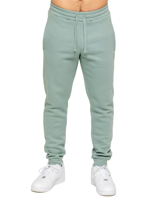 Experience ultimate comfort in our Enzo Mens Regular Fit Joggers. Made with a soft brushed back inner fleece lining, these joggers are perfect for casual wear. The cuffed leg design and elasticated waist with drawstrings provide the perfect fit. With 2 side slash pockets, you can easily carry your essentials.