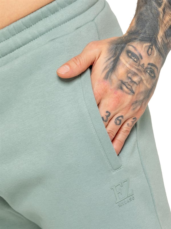Experience ultimate comfort in our Enzo Mens Regular Fit Joggers. Made with a soft brushed back inner fleece lining, these joggers are perfect for casual wear. The cuffed leg design and elasticated waist with drawstrings provide the perfect fit. With 2 side slash pockets, you can easily carry your essentials.