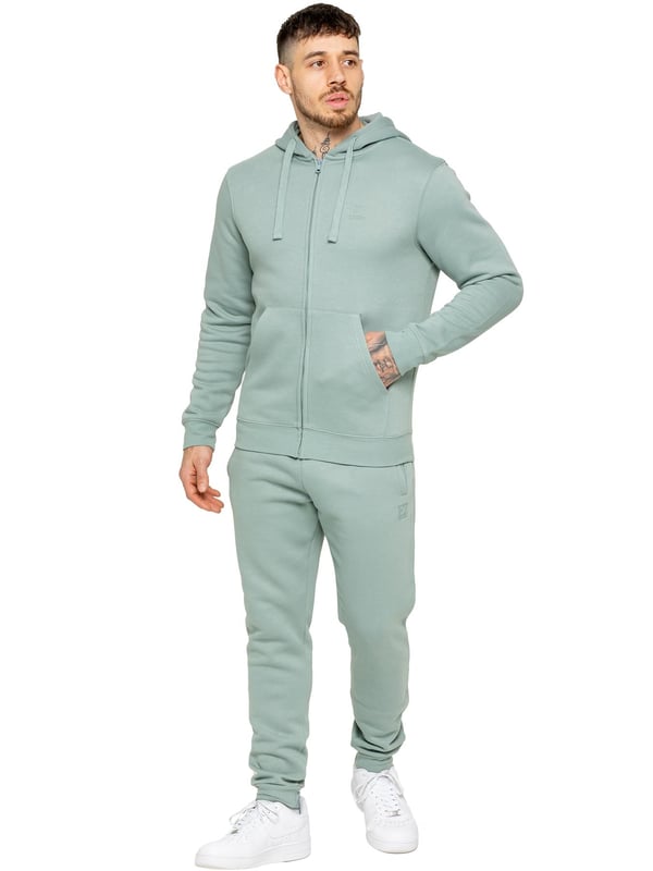 Experience ultimate comfort in our Enzo Mens Regular Fit Joggers. Made with a soft brushed back inner fleece lining, these joggers are perfect for casual wear. The cuffed leg design and elasticated waist with drawstrings provide the perfect fit. With 2 side slash pockets, you can easily carry your essentials.