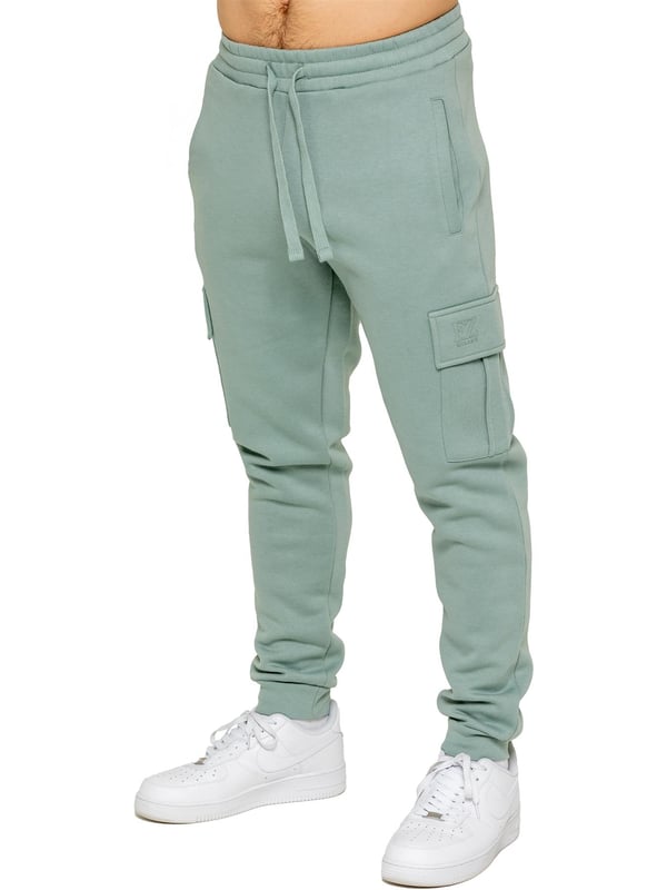 Enzo | Mens Cargo Joggers Experience superior comfort and style with Enzo Men's Regular Fit Cargo Joggers! Crafted with a brushed back inner fleece lining, these joggers are designed to keep you cozy all day long. Perfect for casual wear, they feature convenient 2 side slash pockets and 2 cargo pockets, providing ample storage space for your essentials. Stay on-trend with the cuffed leg design, offering a modern silhouette and added comfort.
