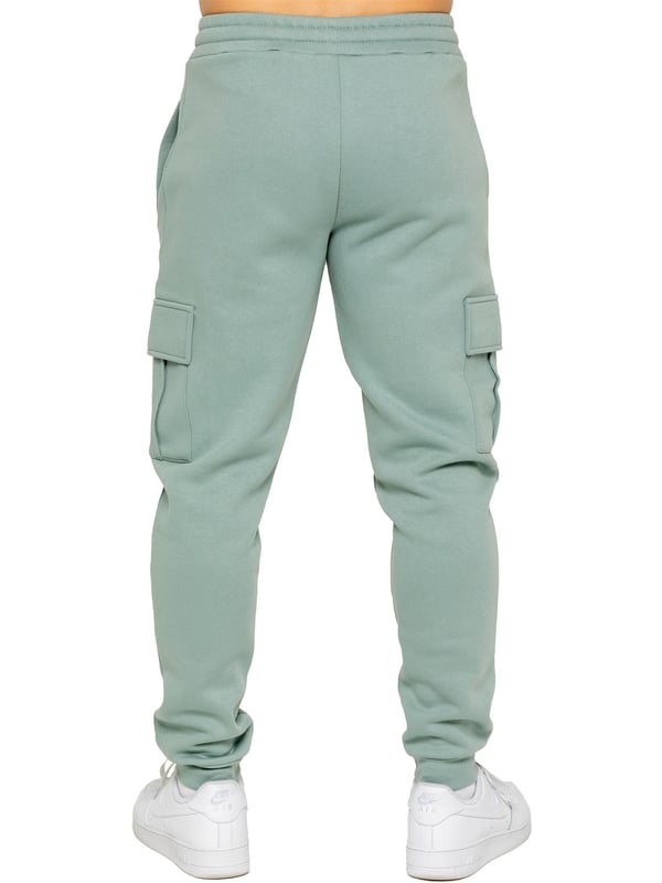 Enzo | Mens Cargo Joggers Experience superior comfort and style with Enzo Men's Regular Fit Cargo Joggers! Crafted with a brushed back inner fleece lining, these joggers are designed to keep you cozy all day long. Perfect for casual wear, they feature convenient 2 side slash pockets and 2 cargo pockets, providing ample storage space for your essentials. Stay on-trend with the cuffed leg design, offering a modern silhouette and added comfort.