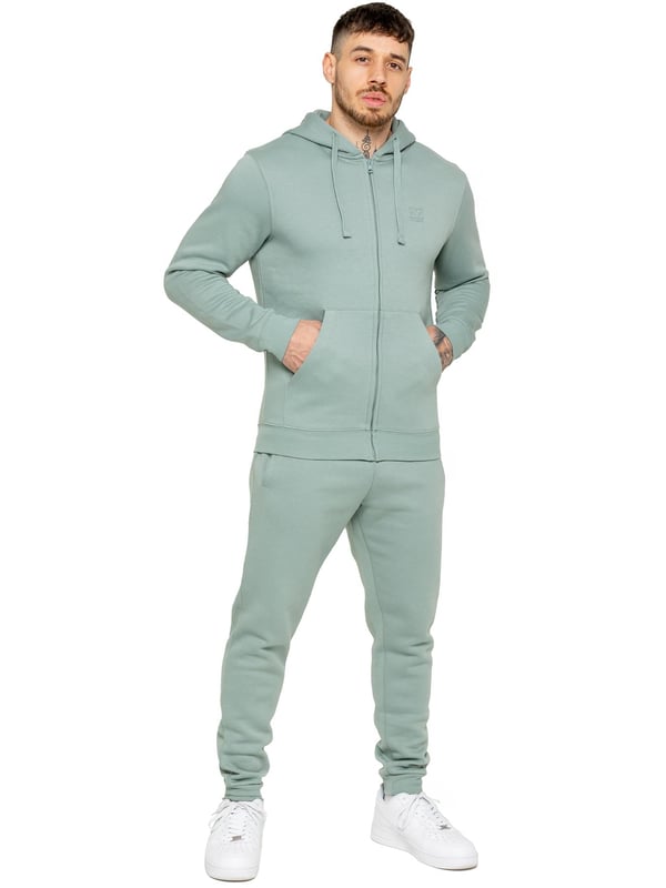 Be ready to conquer any day in the Enzo Mens Zip Hoodie Tracksuit Set. With its comfortable regular fit, long sleeve zip hoodie with cuffed wrists, and adjustable drawstrings, this set will have you looking and feeling your best. The joggers feature the iconic EZ logo and also have a regular fit with cuffed legs and an elasticated waistband with a drawstring for a custom fit. The set is functional with 2 side slash pockets and a single welt back pocket, making it perfect for both casual and work wear.