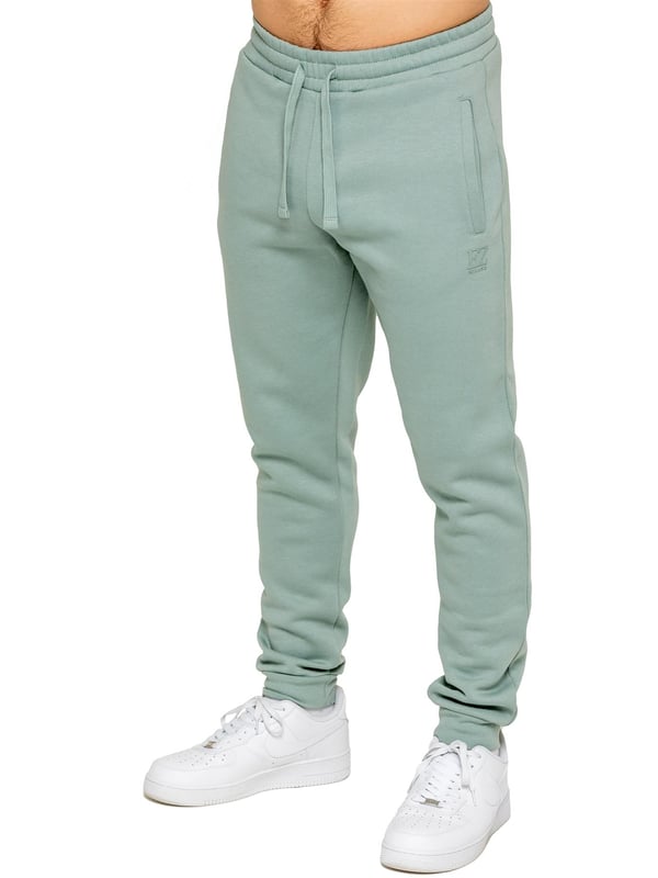 Be ready to conquer any day in the Enzo Mens Zip Hoodie Tracksuit Set. With its comfortable regular fit, long sleeve zip hoodie with cuffed wrists, and adjustable drawstrings, this set will have you looking and feeling your best. The joggers feature the iconic EZ logo and also have a regular fit with cuffed legs and an elasticated waistband with a drawstring for a custom fit. The set is functional with 2 side slash pockets and a single welt back pocket, making it perfect for both casual and work wear.