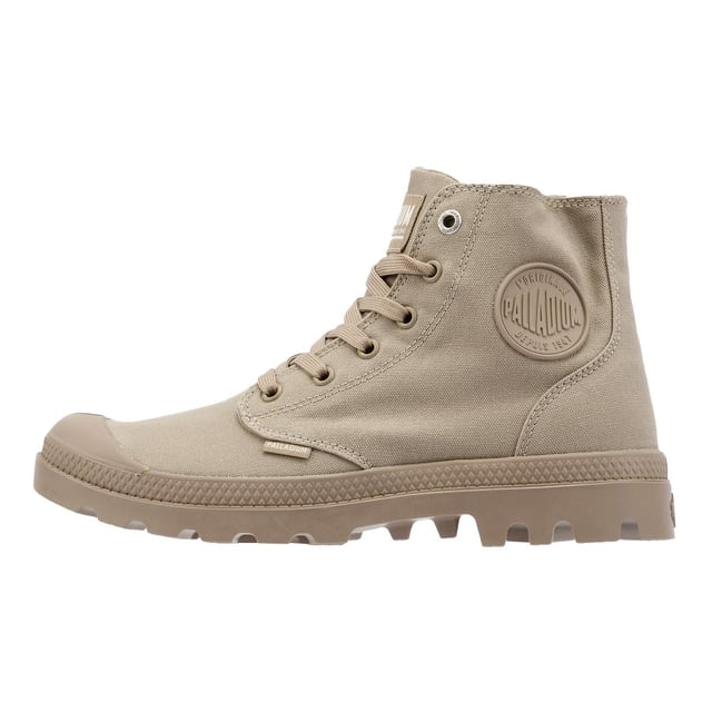 Elevate your streetwear with the athletic version Pampa Hi sneakerboot. Featuring a durable canvas upper in a rugged monochrome colorway, this versatile boot is built for both style and function. Designed for long-lasting comfort, it includes a hard-wearing lugged rubber outsole, a supportive heel cup cradle, and a protective rubber toe cap. Finished with the signature Palladium ankle patch and woven tag for an authentic touch.
