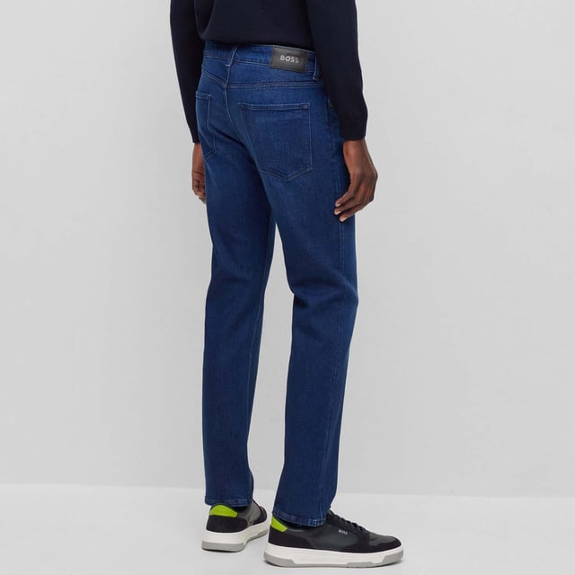 Men's Boss Maine Slim-Fit Jeans. These classic straight-leg jeans, made from premium cotton, feature five pockets, belt loops, and a zip fly with button fastening. Finished in a solid color with open cuffs and Boss branding, they offer both comfort and sophistication. Material: 60% Cotton, 39% Lyocell, 1% Elastane. Ref: 50496199430.