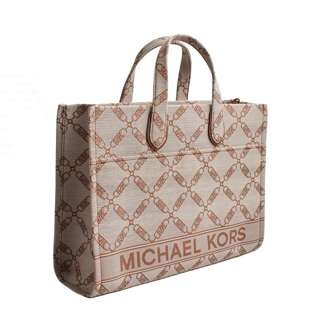 The Michael Kors Gigi tote is the perfect complement to virtually any look thanks to its neutral-toned jacquard chain and logo pattern. The large rectangular silhouette is the perfect size to carry just your everyday essentials and includes a versatile crossbody strap. Inside, there are convenient pockets for your keys and phone.

 Details:
 - Accessory Type: Tote Bag.
 - Material: Synthetic material with the repeated Empire logo.
 - Interior details: Back zipper pocket, 2 front pockets.
 - Exterior details: Front pocket with magnetic closure.
 - Handles: Double.
 - Includes shoulder strap and storage bag.
 - Closure: No closure.

 Each of Michael Kors' accessories collections boasts a strong identity, offering a fresh mix of timeless trends, colors, and silhouettes, combined with urban style and attitude. Each women's tote bag designed by Michael Kors is an affordable luxury with a touch of modern, unexpected, and comfortable glamour, offering a piece for every occasion.
 Measures: 39.4 cm x 29.8 cm x 13.3 cm
 Composition: 53.2% Cotton, 46.8% Polyester
 Care:
Clean with a soft, dry cloth.
 Avoid prolonged exposure to the sun and humidity.
 Avoid contact with liquids and rough surfaces.