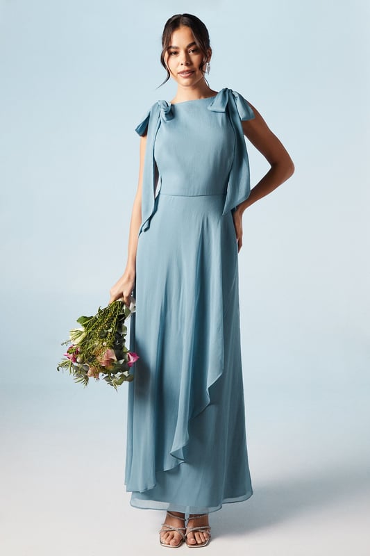 Elegant one-shoulder design with tie detail
        Flowing chiffon fabric for graceful movement
        Flattering waterfall drape enhancing the silhouette
        Floor-length maxi style for a sophisticated look
        Versatile design suitable for various bridesmaid styles
    
    This exquisite bridesmaid dress from Coast embodies timeless elegance and feminine charm. The one-shoulder neckline with delicate tie detail adds a touch of romance, while the flowing chiffon fabric ensures graceful movement as you glide down the aisle. The waterfall drape cascades beautifully, creating a flattering silhouette that complements various body types. Perfect for weddings in any season, this maxi dress can be styled to suit different themes and colour palettes. Pair with strappy heels and delicate jewellery for a polished look that will complement the bride's ensemble. The versatile design allows for easy coordination with other bridesmaids, ensuring a cohesive and stunning bridal party. This Coast dress is a beautiful choice for those seeking a blend of sophistication and modern style for their special role in the wedding celebration.
