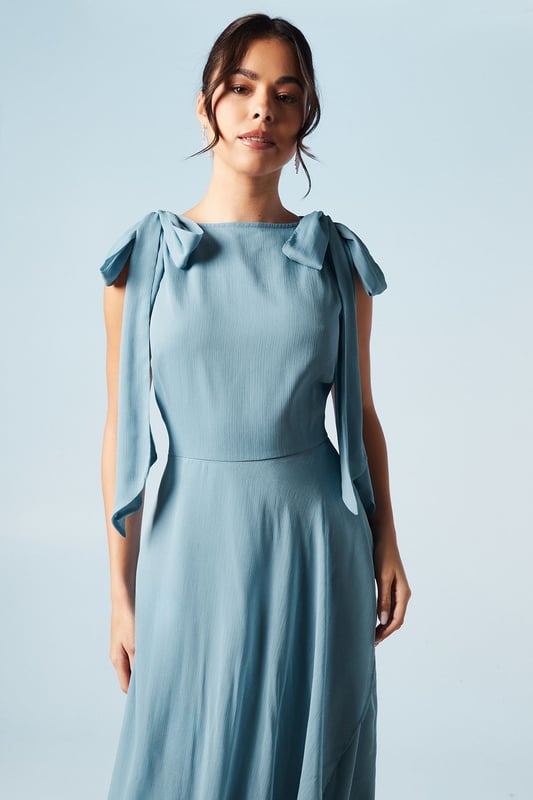 Elegant one-shoulder design with tie detail
        Flowing chiffon fabric for graceful movement
        Flattering waterfall drape enhancing the silhouette
        Floor-length maxi style for a sophisticated look
        Versatile design suitable for various bridesmaid styles
    
    This exquisite bridesmaid dress from Coast embodies timeless elegance and feminine charm. The one-shoulder neckline with delicate tie detail adds a touch of romance, while the flowing chiffon fabric ensures graceful movement as you glide down the aisle. The waterfall drape cascades beautifully, creating a flattering silhouette that complements various body types. Perfect for weddings in any season, this maxi dress can be styled to suit different themes and colour palettes. Pair with strappy heels and delicate jewellery for a polished look that will complement the bride's ensemble. The versatile design allows for easy coordination with other bridesmaids, ensuring a cohesive and stunning bridal party. This Coast dress is a beautiful choice for those seeking a blend of sophistication and modern style for their special role in the wedding celebration.