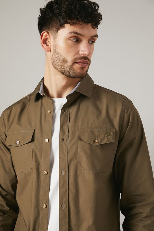 Versatile long sleeve shirt in poplin fabric
        Double chest pockets with button closures
        Classic collar and full-length button placket
        Adjustable cuffs for a customised fit
        Subtle brand detailing on the back yoke
    
    This Maine khaki poplin shirt is a wardrobe essential that seamlessly blends functionality with style. The double chest pockets add a utilitarian touch, perfect for those who appreciate practicality in their attire. Its versatile design makes it suitable for a range of casual occasions, from laid-back weekend brunches to family gatherings. Style it as seen on our model - pair it with dark trousers and white trainers for a smart-casual look that's effortlessly cool. For a more relaxed vibe, leave it unbuttoned over a plain white tee and combine with your favourite jeans. The adjustable cuffs allow you to roll up the sleeves for a more casual appearance or keep them buttoned for a neater finish. This shirt is a true chameleon in your wardrobe, easily dressed up or down to suit your needs, making it an indispensable piece for the modern British man.