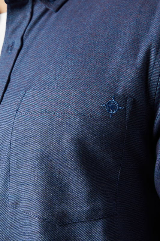 Tri-colour brushed check pattern for visual interest
        Button-down collar for a smart-casual look
        Long sleeves with adjustable cuffs
        Single chest pocket for practicality
        Versatile woven fabric suitable for various occasions
    
    This Maine long sleeve shirt showcases a distinctive tri-colour brushed check pattern, offering a stylish twist on a classic design. The button-down collar adds a touch of refinement, making it suitable for both casual outings and slightly dressier events. For a laid-back weekend look, pair it with olive chinos and white trainers as shown. Alternatively, dress it up for a smart-casual office environment by tucking it into tailored trousers and adding a blazer. The versatile nature of this shirt makes it an excellent choice for family gatherings, pub outings with mates, or casual Fridays at work. Its woven fabric ensures comfort and durability, while the adjustable cuffs allow for a customised fit. Whether worn open over a plain t-shirt or buttoned up with a tie, this Maine shirt is sure to become a staple in your wardrobe.