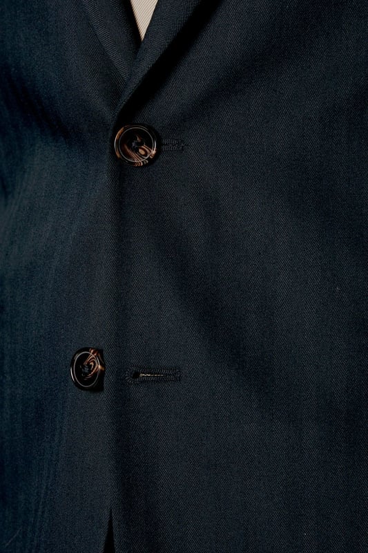 Tailored fit for a refined silhouette
        Distinctive herringbone pattern adds texture
        Notched lapels for classic sophistication
        Two-button front closure for versatile styling
        Flap pockets and a chest welt pocket for functionality
    
    This Burton herringbone suit jacket is the epitome of smart, sophisticated style. The tailored fit sculpts your silhouette while offering ease of movement, perfect for the modern gent who appreciates classic design with a contemporary edge. Ideal for a range of occasions, from important business meetings to smart-casual events at the local pub. Pair with matching trousers and a crisp white shirt for a complete look, or dress it down with dark denim and a light jumper for a more relaxed ensemble. The versatile nature of this jacket makes it a staple for any wardrobe, easily transitioning from day to night. Whether you're heading to the office, attending a wedding, or meeting friends for a posh night out, this jacket will ensure you look polished and put-together.