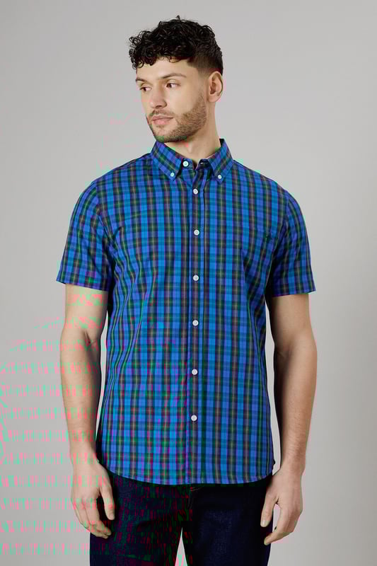 Vibrant tartan check pattern in bright blue tones
        Short sleeve design for warm-weather comfort
        Button-down collar for a smart-casual look
        Woven cotton fabric for breathability
        Versatile fit suitable for various body types
    
    This Maine short sleeve shirt presents a perfect blend of casual charm and smart styling. The eye-catching tartan check pattern in bright blue hues adds a pop of colour to your wardrobe, making it an ideal choice for those seeking to inject some personality into their everyday attire. Whether you're heading to a family barbecue or a casual Friday at the office, this shirt offers versatility in spades. Pair it with dark wash jeans and white trainers for a laid-back look, or dress it up with chinos and loafers for a more polished ensemble. The button-down collar adds a touch of refinement, while the short sleeves keep you cool and comfortable during warmer days. Crafted from woven cotton, this shirt ensures breathability and ease of movement, making it a go-to option for long summer days or relaxed weekend outings. Its adaptable fit flatters various body types, making it a wardrobe staple that you'll reach for time and time again.