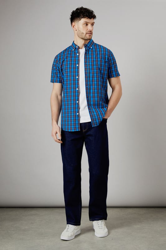 Vibrant tartan check pattern in bright blue tones
        Short sleeve design for warm-weather comfort
        Button-down collar for a smart-casual look
        Woven cotton fabric for breathability
        Versatile fit suitable for various body types
    
    This Maine short sleeve shirt presents a perfect blend of casual charm and smart styling. The eye-catching tartan check pattern in bright blue hues adds a pop of colour to your wardrobe, making it an ideal choice for those seeking to inject some personality into their everyday attire. Whether you're heading to a family barbecue or a casual Friday at the office, this shirt offers versatility in spades. Pair it with dark wash jeans and white trainers for a laid-back look, or dress it up with chinos and loafers for a more polished ensemble. The button-down collar adds a touch of refinement, while the short sleeves keep you cool and comfortable during warmer days. Crafted from woven cotton, this shirt ensures breathability and ease of movement, making it a go-to option for long summer days or relaxed weekend outings. Its adaptable fit flatters various body types, making it a wardrobe staple that you'll reach for time and time again.