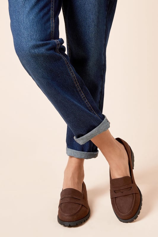 Chunky faux leather loafers with a wide fit for added comfort
Sleek and minimal design with a classic penny loafer silhouette
Durable and textured rubber outsole for enhanced traction
Slightly raised heel for a subtle lift
Easy slip-on style with a convenient loafer construction

These wide fit loafers from Dorothy Perkins exude a timeless and versatile appeal, making them an ideal choice for casual everyday wear. The faux leather upper lends a polished look, while the chunky sole adds a contemporary touch. Pair them with tailored trousers or a flowy dress for a chic and effortless ensemble, perfect for brunch dates, family gatherings, or casual outings with friends. Their comfortable wide fit ensures all-day wearability, allowing you to step out in style without compromising on practicality.