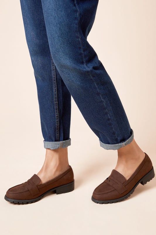 Chunky faux leather loafers with a wide fit for added comfort
Sleek and minimal design with a classic penny loafer silhouette
Durable and textured rubber outsole for enhanced traction
Slightly raised heel for a subtle lift
Easy slip-on style with a convenient loafer construction

These wide fit loafers from Dorothy Perkins exude a timeless and versatile appeal, making them an ideal choice for casual everyday wear. The faux leather upper lends a polished look, while the chunky sole adds a contemporary touch. Pair them with tailored trousers or a flowy dress for a chic and effortless ensemble, perfect for brunch dates, family gatherings, or casual outings with friends. Their comfortable wide fit ensures all-day wearability, allowing you to step out in style without compromising on practicality.