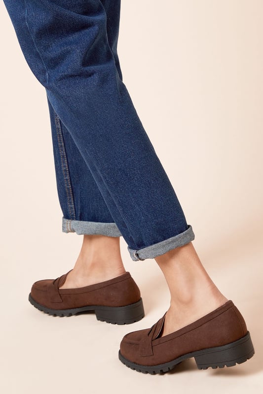Chunky faux leather loafers with a wide fit for added comfort
Sleek and minimal design with a classic penny loafer silhouette
Durable and textured rubber outsole for enhanced traction
Slightly raised heel for a subtle lift
Easy slip-on style with a convenient loafer construction

These wide fit loafers from Dorothy Perkins exude a timeless and versatile appeal, making them an ideal choice for casual everyday wear. The faux leather upper lends a polished look, while the chunky sole adds a contemporary touch. Pair them with tailored trousers or a flowy dress for a chic and effortless ensemble, perfect for brunch dates, family gatherings, or casual outings with friends. Their comfortable wide fit ensures all-day wearability, allowing you to step out in style without compromising on practicality.
