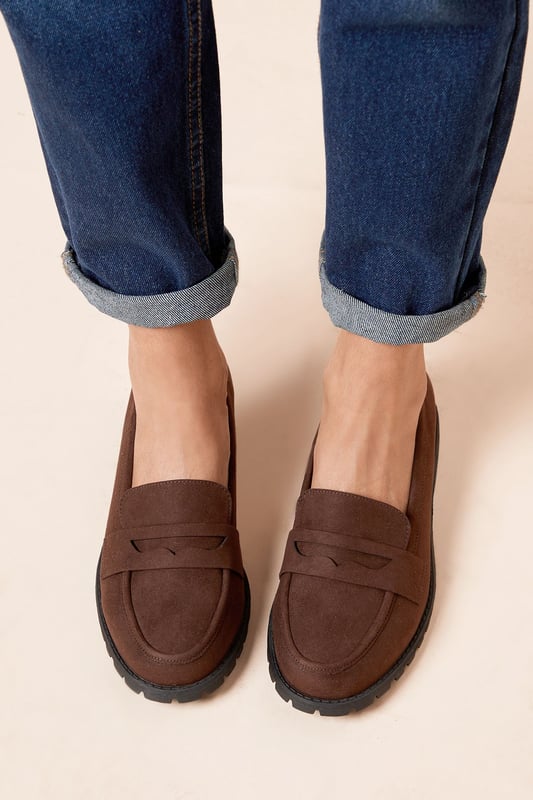 Chunky faux leather loafers with a wide fit for added comfort
Sleek and minimal design with a classic penny loafer silhouette
Durable and textured rubber outsole for enhanced traction
Slightly raised heel for a subtle lift
Easy slip-on style with a convenient loafer construction

These wide fit loafers from Dorothy Perkins exude a timeless and versatile appeal, making them an ideal choice for casual everyday wear. The faux leather upper lends a polished look, while the chunky sole adds a contemporary touch. Pair them with tailored trousers or a flowy dress for a chic and effortless ensemble, perfect for brunch dates, family gatherings, or casual outings with friends. Their comfortable wide fit ensures all-day wearability, allowing you to step out in style without compromising on practicality.