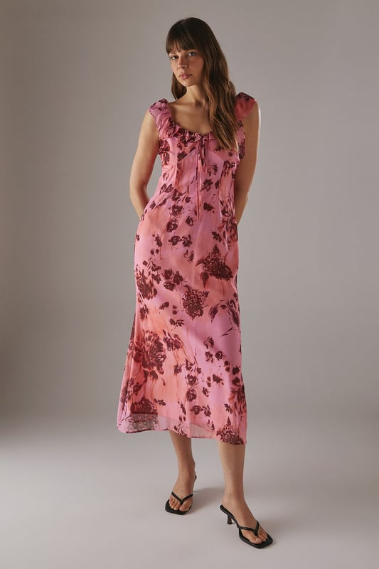 Chiffon fabric with floral print for a light, airy feel
        Double-layered design for added movement and depth
        Ruffle detailing along neckline and shoulders
        Midi length for versatile styling options
        Open back design with delicate ruffle trim
    
    This enchanting midi dress radiates effortless femininity with its flowing chiffon fabric and captivating floral print. The double-layered design adds a touch of sophistication, while the ruffle detailing along the neckline and shoulders creates a romantic silhouette. Perfect for a variety of casual occasions, this dress can be styled with flat sandals for a relaxed daytime look or dressed up with heeled mules for evening gatherings. The open back with ruffle trim adds an unexpected twist, making it an ideal choice for garden parties or summer weddings. Layer with a lightweight cardigan for cooler evenings or pair with statement earrings to enhance its feminine charm. This versatile piece from Warehouse embodies confidence and style, making it a must-have addition to your wardrobe for those moments when you want to feel both comfortable and effortlessly chic.