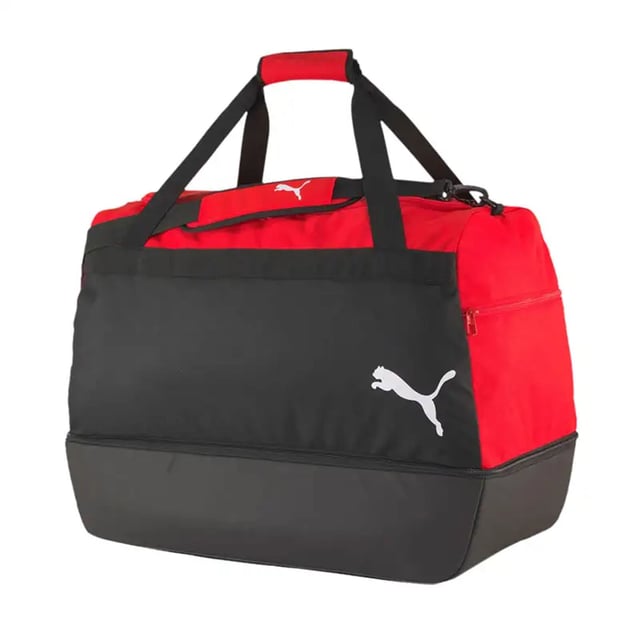 The Puma TeamGoal 23 Black/Red Hardcase Bag is designed for athletes who need a tough, durable, and spacious bag to carry their gear. With a strong hardcase structure and ample storage space, this bag ensures your equipment stays safe and organized during transport. Whether you're heading to a match, training, or traveling, this bag provides superior protection for your gear, all while offering a sleek, stylish design.
Key Features:
Hardcase Structure: 

The hardcase construction provides added protection for your sports equipment, ensuring that your gear is safeguarded from external damage during travel or handling.


Large Capacity: 

The bag offers ample storage space, allowing you to easily store your football gear, clothing, shoes, and other essentials. Itâ€™s perfect for athletes who need to carry multiple items at once.


Durable Design: 

Made from high-quality, durable materials, this bag is built to withstand frequent use, ensuring long-lasting performance even in demanding environments.


Multiple Pockets: 

Equipped with side zip pockets and a front compartment, the bag helps you organize smaller items like keys, phone, or accessories, keeping everything easily accessible.


Comfortable Carrying Options: 

The bag features padded shoulder straps and reinforced carry handles, providing various options for comfortable and secure transportation.


Sleek Black/Red Colorway: 

The black and red design gives the bag a bold, sporty look, making it easy to match with your other sportswear or equipment.


Puma Branding: 

The Puma logo is prominently displayed, showing off your connection to a trusted brand in sports gear and athletic accessories.


The Puma TeamGoal 23 Black/Red Hardcase Bag is the perfect choice for athletes who need a durable, spacious, and protective bag for their gear. With its hardcase design, multiple compartments, and stylish colorway, it offers both functionality and a modern look. Whether you're traveling for a match or heading to training, this bag has everything you need to keep your gear safe and organized.