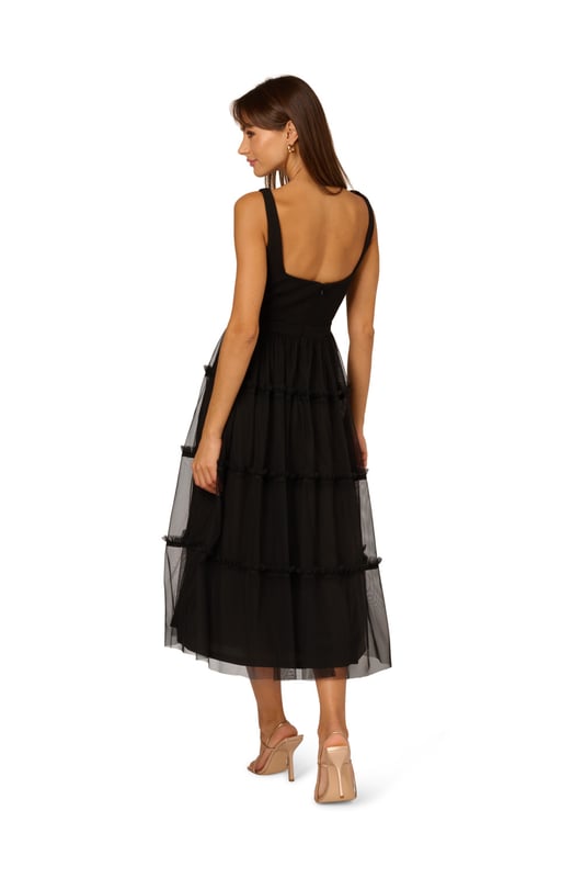 Modern fabric mixes make this classic fit and flare dress a sweet look. This midi dress features a fitted bodice with tank straps, a square neckline, and a tiered skirt. Fully lined, the bodice is crafted from a knit fabrication while the skirt is overlaid in mesh for added sweep. Pockets and a square back with centre zip closure complete this delightful party dress. Styled with nude heels and sparkling accessories, this midi dress is a timeless look from wedding guest duty to cocktail parties