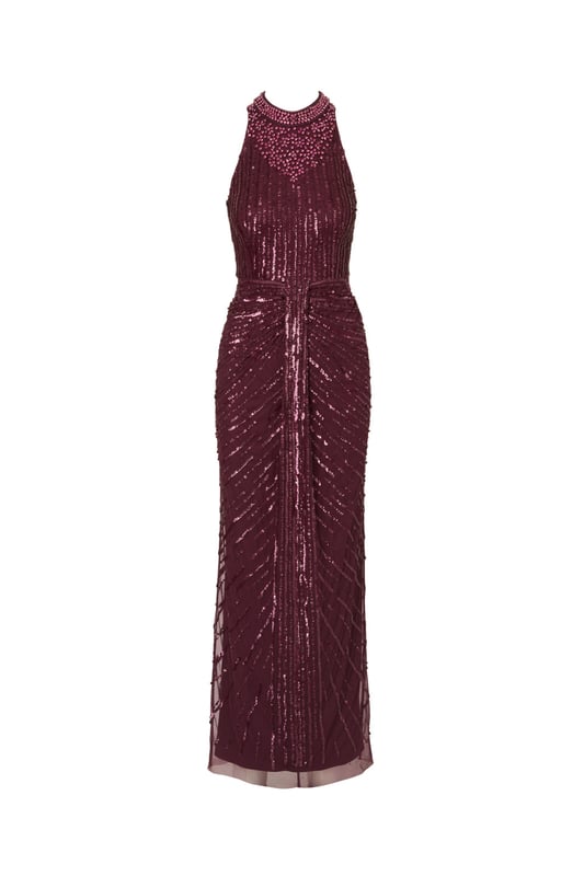 Deco details make this halter gown outshine the competition. This formal dress features a halter bodice, mock neckline, and a column skirt. Draped details at the skirt adds drama to this sleeveless gown. Crafted from mesh knit fabric and embellished with a chic mix of sequins, beading and gems in a design that accentuates the figure. A hidden zipper closure completes this beaded gown. Nude heels and a satin clutch are all this black-tie dress needs to shine all night long.