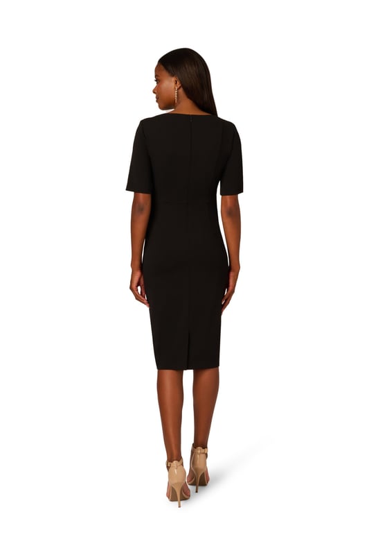 Wherever you go, go boldly in this three-quarter sleeve dress. Crafted from luxurious knit crepe fabric, this dress drapes beautifully while offering comfort and style. The ruffle mock neck adds a touch of femininity, complemented by practical pockets for added functionality. Complete with a self-tie bow at the neck for a hint of femininity, this dress effortlessly transitions from day to evening, making it a versatile addition to any wardrobe. Perfect for both casual outings and special occasions, you will love dressing this trapeze dress up or down.
