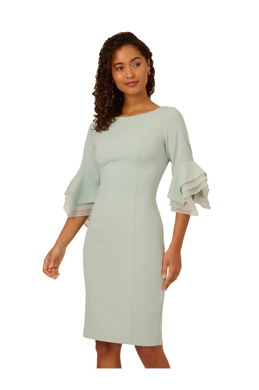 Dressed up meets versatile in this timeless sheath dress. This midi dress features a boat neckline, fitted silhouette through the body, and tiered three-quarter bell sleeves with organza accents. Crafted using knit crepe, this day dress has some stretch and no waist seam for a comfortable fit. A zipper back closure and a single pleat at the centre back of the skirt hem completes the design.