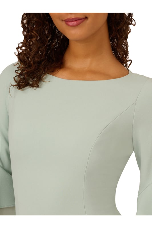Dressed up meets versatile in this timeless sheath dress. This midi dress features a boat neckline, fitted silhouette through the body, and tiered three-quarter bell sleeves with organza accents. Crafted using knit crepe, this day dress has some stretch and no waist seam for a comfortable fit. A zipper back closure and a single pleat at the centre back of the skirt hem completes the design.