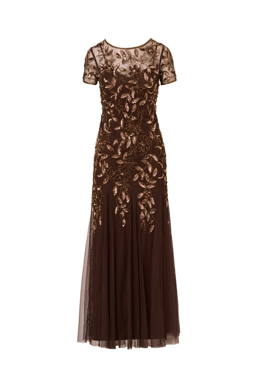 Our long and romantic gown dazzles with all-over handsewn beading in a feminine floral pattern that catches the light with every twirl. A streamlined silhouette is eased with the mermaid skirt with godets to create the right amount of movement. Our iconic and flattering no waist seam, sheer illusion yoke and cap sleeves. Sleek back zip closure.