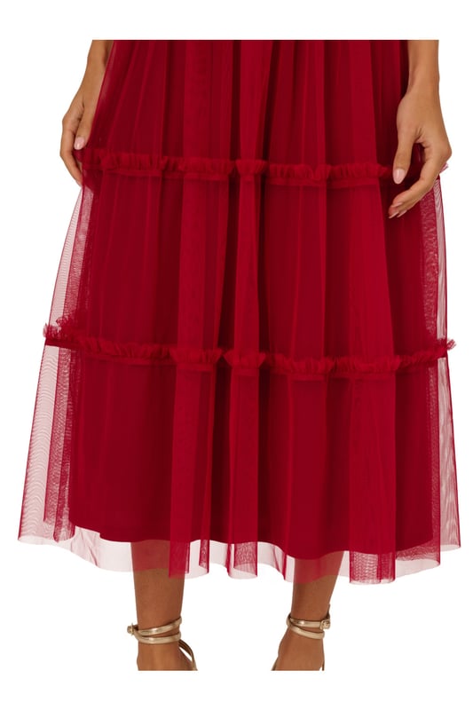 Modern fabric mixes make this classic fit and flare dress a sweet look. This midi dress features a fitted bodice with tank straps, a square neckline, and a tiered skirt. Fully lined, the bodice is crafted from a knit fabrication while the skirt is overlaid in mesh for added sweep. Pockets and a square back with centre zip closure complete this delightful party dress. Styled with nude heels and sparkling accessories, this midi dress is a timeless look from wedding guest duty to cocktail parties
