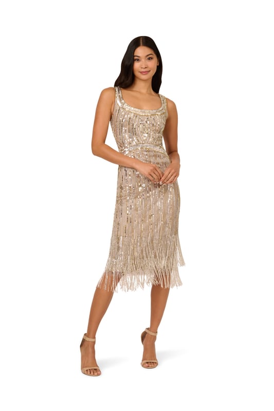 The all-over linear sequin and bead embellishment on this shimmering sleeveless cocktail dress defines your waist and bust with clever pattern placement. The star of the show is the fringe hem with two layers of beaded fringe to give the look lots of extra sparkle. A back zipper finishes the design. Wear this dress anytime you are planning to hit the dance floor, because this style is made to catch the light with every movement.