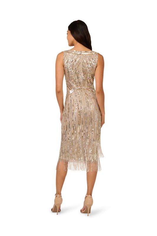 The all-over linear sequin and bead embellishment on this shimmering sleeveless cocktail dress defines your waist and bust with clever pattern placement. The star of the show is the fringe hem with two layers of beaded fringe to give the look lots of extra sparkle. A back zipper finishes the design. Wear this dress anytime you are planning to hit the dance floor, because this style is made to catch the light with every movement.