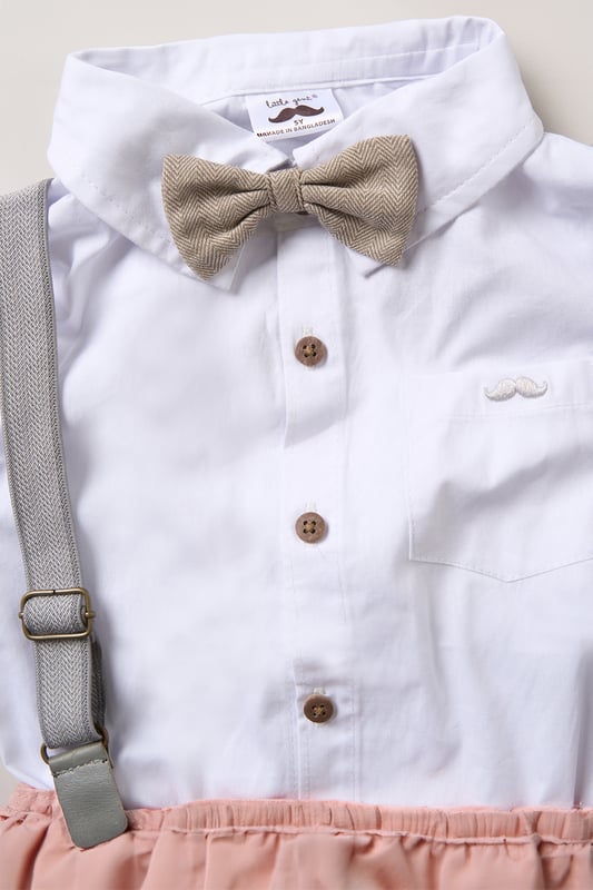 Shirt, Shorts and Braces Outfit Set Dress your little one to impress with this delightful set from Little Gent. Featuring a shirt, bowtie, and shorts with attached braces. Perfect for special occasions or stylish outings, your little one will look effortlessly dapper and be ready to steal the spotlight!