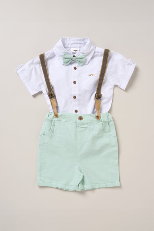 Shirt, Shorts and Braces Outfit Set Dress your little one to impress with this delightful set from Little Gent. Featuring a shirt, bowtie, and shorts with attached braces. Perfect for special occasions or stylish outings, your little one will look effortlessly dapper and be ready to steal the spotlight!