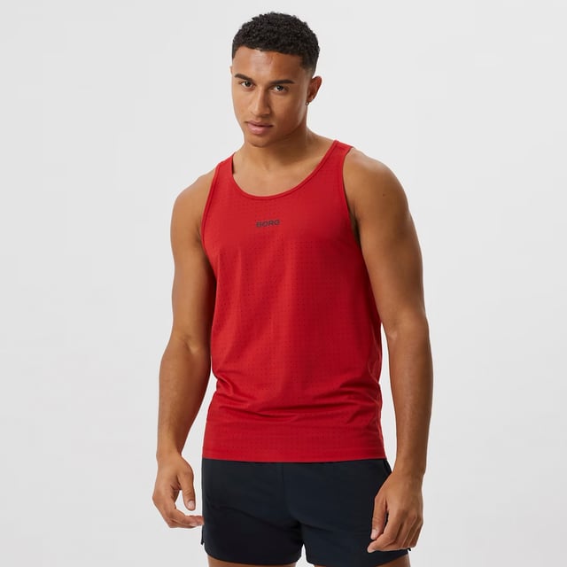 Borg Running Perforated Tank - Breathable and Lightweight Performance: Elevate your running gear with the Björn Borg Borg Running Perforated Tank, designed for athletes who value breathability and comfort. Made from lightweight, recycled polyester, this tank top features perforated fabric for enhanced ventilation, keeping you cool during intense workouts. It offers a regular fit and is perfect for warmer weather or layering. Extra Product Details:. 100% Recycled Polyester Regular Fit Perforated Fabric for breathability Round Neckline Machine Washable. This tank is a must-have for runners looking for a combination of style and performance in their gear.