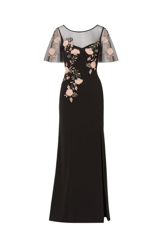 Beaded Crepe Long Dress Lean into formal season with this sweetly beaded gown. This formal dress features a fitted bodice with boat neckline, a sheer yoke that gives a sweetheart neckline illusion, sheer flutter sleeves and a mermaid skirt with thigh-high slit. Crafted from crepe fabric through the body, this dress has knit mesh at the bodice and sleeves that is embellished with beautiful sequin beaded florals. A hidden zipper closure at the sheer v-back completes this black-tie dress. Styled with neutral accessories that let the floral beading shine, this flutter short sleeve gown is a romantic look.