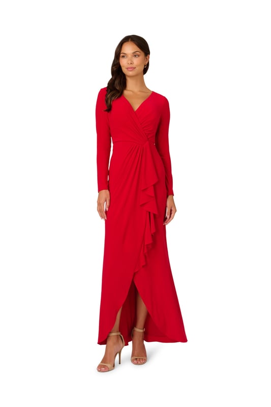 Slinky jersey fabric gives this long sleeve gown dramatic drape and exceptional comfort. A faux wrap construction gives the long dress design dynamic lines across the bodice and down the front of the flowing skirt. The back closes with a zipper and finishes with flattering ruching at the centre hip.