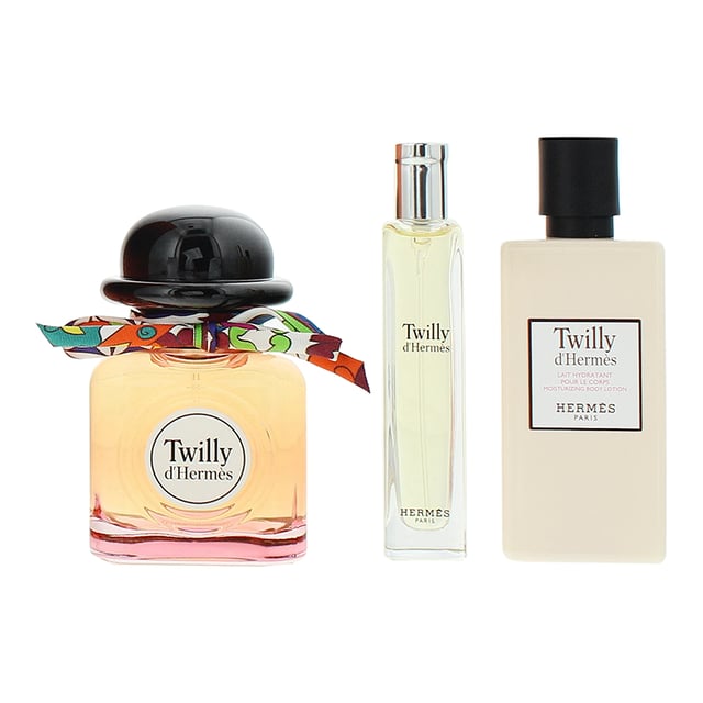 Hermes Twilly D'Hermes 3 Piece Gift Set features the iconic Eau De Parfum in two sizes along with a luxurious Moisturizing Body Lotion. The fragrance opens with lively ginger, bitter orange, and bergamot, giving it a vibrant and fresh start. The heart reveals a rich floral bouquet of tuberose, orange blossom, and jasmine, adding depth and elegance. The base notes of sandalwood and vanilla provide warmth and a sensual finish. This set offers a complete fragrance experience, allowing you to enjoy the elegant scent at home and on the go, while the body lotion hydrates and softens the skin with the same delightful aroma.