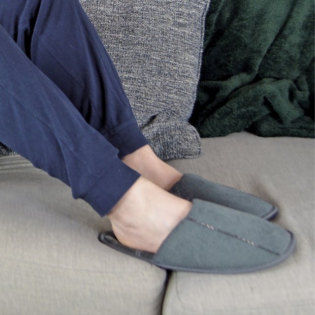 Relax your feet in these super soft and lightly cushioned mule slippers for men. Whether you're working from home, or lounging around indoors, these mule slippers are soft to the touch! Why not treat a loved one, or yourself, to these comfortable and warm mule slippers? They feature a light cushioned sole to help alleviate any pressure and fatigued feeling you may experience in your heels. The insole has a chequered pattern for a trendy look which will match any pair of socks and casual lounge wear! Made from indoor use, these mule slippers have a non-slip hard wearing sole to prevent any slipping or sliding on tiled or wooden flooring. If you're looking to make a fashion statement, these slippers feature a trim on top and around the slipper. With a convenient hands-free slip-on style, these slippers have a spacious opening back design, making them easy to slip on and off. These slippers are available in colours Navy and Grey. They come in mens sizes 7-12 UK, 41-46 EU, 8-13 US.