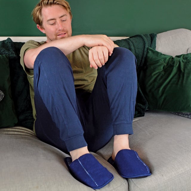 Relax your feet in these super soft and lightly cushioned mule slippers for men. Whether you're working from home, or lounging around indoors, these mule slippers are soft to the touch! Why not treat a loved one, or yourself, to these comfortable and warm mule slippers? They feature a light cushioned sole to help alleviate any pressure and fatigued feeling you may experience in your heels. The insole has a chequered pattern for a trendy look which will match any pair of socks and casual lounge wear! Made from indoor use, these mule slippers have a non-slip hard wearing sole to prevent any slipping or sliding on tiled or wooden flooring. If you're looking to make a fashion statement, these slippers feature a trim on top and around the slipper. With a convenient hands-free slip-on style, these slippers have a spacious opening back design, making them easy to slip on and off. These slippers are available in colours Navy and Grey. They come in mens sizes 7-12 UK, 41-46 EU, 8-13 US.