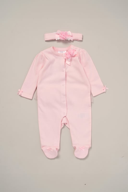 Rose Ribbon Detail All-In-One and Headband Outfit Set This Charming Ribbon Detail All-In-One Set from Rock A Bye Baby Boutique features a button-up all-in-one adorned with a lovely rose ribbon, complete with matching headband also adorned with a rose ribbon. Adding to its adorable charm, the set features a tutu skirt on the back, enhancing its sweet appeal. Each set also comes with a hanger, ensuring easy storage and display. Dress your little one in style and comfort with this set from Rock A Bye Baby Boutique.