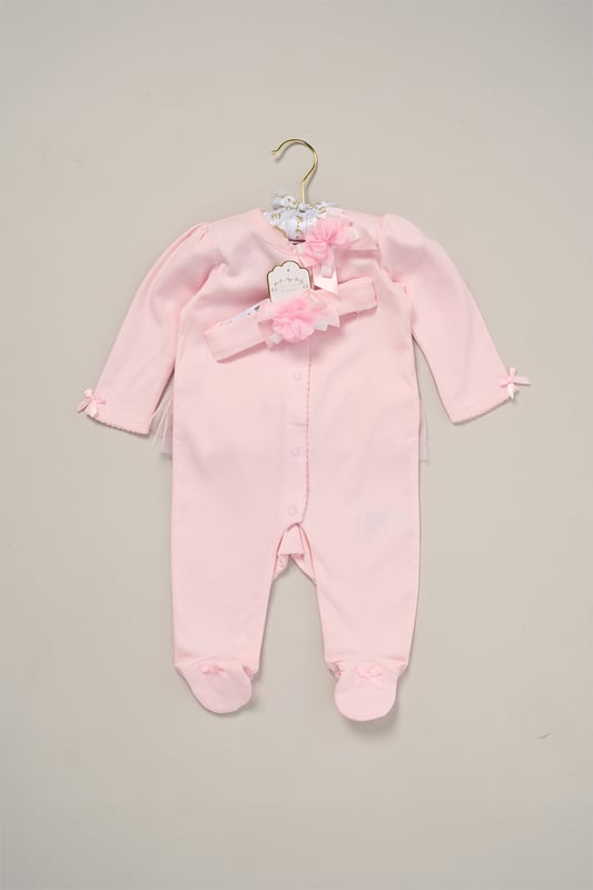 Rose Ribbon Detail All-In-One and Headband Outfit Set This Charming Ribbon Detail All-In-One Set from Rock A Bye Baby Boutique features a button-up all-in-one adorned with a lovely rose ribbon, complete with matching headband also adorned with a rose ribbon. Adding to its adorable charm, the set features a tutu skirt on the back, enhancing its sweet appeal. Each set also comes with a hanger, ensuring easy storage and display. Dress your little one in style and comfort with this set from Rock A Bye Baby Boutique.