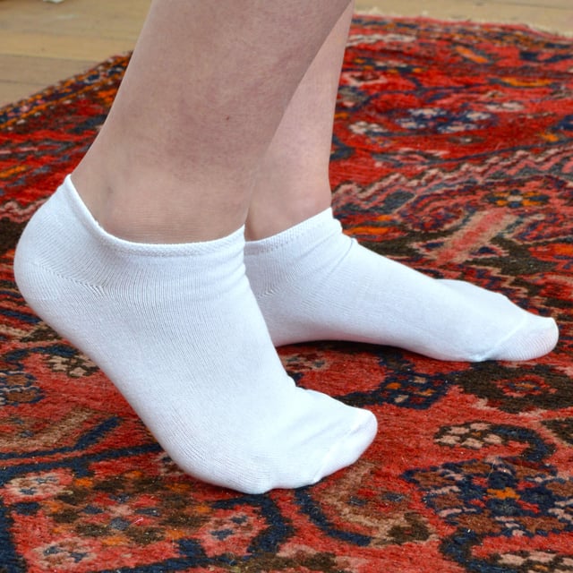 Mens Sock Snob Cotton Trainer Socks Bulk Value Deal - 24 Pairs: Looking for the ultimate bulk value deal on trainer socks? Look no further! Introducing our Mens Sock Snob Cotton Trainer Socks Bulk Value Pack, offering you an incredible 24 pairs of high-quality socks at an unbeatable price. These trainer socks are crafted with durability and comfort in mind. Made from a premium blend of 75% cotton, they provide a soft and luxurious feel for your feet, whether you're wearing them casually or during intense athletic activities. The high cotton content also ensures breathability, allowing your feet to stay cool and dry even in warmer weather. Designed with your comfort in mind, these ankle-length socks feature a smooth toe seam to reduce irritability, making them perfect for running or playing sports. The knitted construction enhances overall comfort, ensuring a snug fit that stays in place throughout the XXXday. Available in three classic colors - black, grey, and white - these cotton trainer socks are versatile and stylish. Choose from two sizes: 6-11 UK 7-12 US 39-45 EU and 12-14 UK 13-15 US 46-50 EU, ensuring the perfect fit for everyone. And don't worry about maintenance - these socks are machine washable for your convenience. Extra Product Details:: - Mens Cotton Trainer Socks - Sock Snob Bulk Value Pack - 24 Pairs - Premium Soft Cotton - Moisture-Wicking Technology - Breathable and Comfortable - Available in Black, Grey, and White - Two Sizes: 6-11 UK 7-12 US 39-45 EU and 12-14 UK 13-15 US 46-50 EU - Machine Washable
